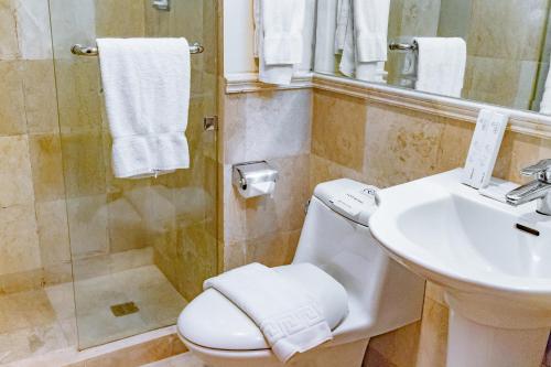 a bathroom with a sink and a toilet and a shower at Crown Regency Prince Resort in Boracay