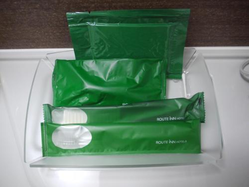 two green bags on top of a white drawer at Hotel Route-Inn Kashiwa Minami -Kokudo 16Gouzoi- in Kashiwa