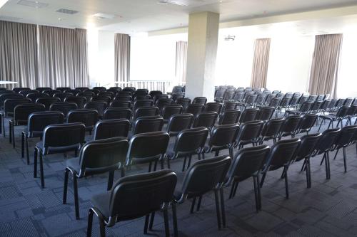 an empty room with chairs in a building at Hotel Nivari Duitama in Duitama