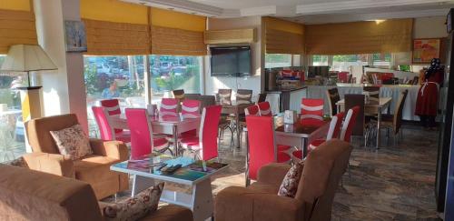 a restaurant with tables and chairs and a dining room at Hotel Villa Granada in Antalya