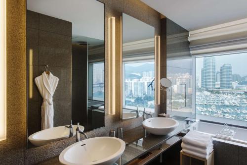 a bathroom with two sinks and a large mirror at Park Hyatt Busan in Busan