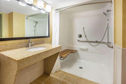 a bathroom with a sink and a shower at Baymont by Wyndham Harrisburg in Harrisburg