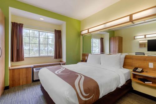 A bed or beds in a room at Quality Inn & Suites Lehigh Acres Fort Myers