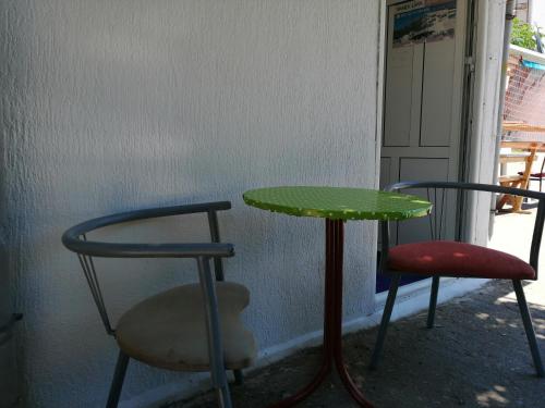 a table and two chairs and a green table and chairs at Aleksandar in Sutomore