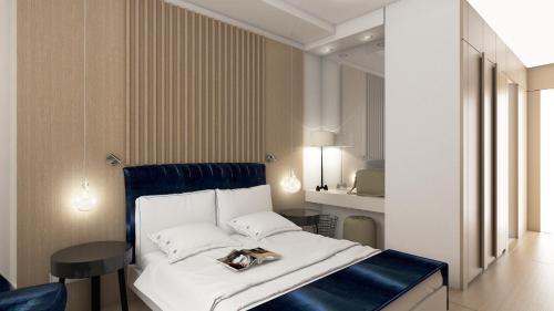 a bedroom with a white bed with a blue head board at Maralia Hotel in Nicosia