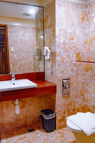 a bathroom with a sink and a toilet at Crown Regency Beach Resort in Boracay