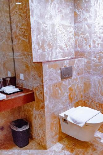 a bathroom with a toilet and a sink at Crown Regency Beach Resort in Boracay