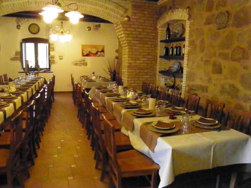 a dining room with long tables with white tablecloths at Sperone agriturismo in Assoro