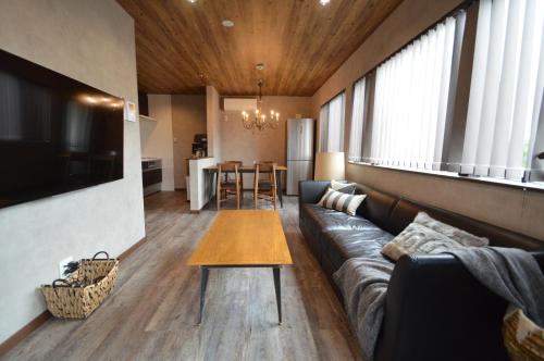 a living room with a couch and a table at enico MtFuji smile in Fujikawaguchiko