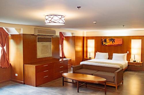 A bed or beds in a room at Crown Regency Beach Resort