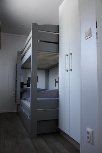 a bedroom with two bunk beds and a closet at Domeček u Prahy in Nupaky