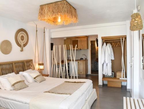 a bedroom with two beds and a kitchen at Angelos Design Suites in Patitiri