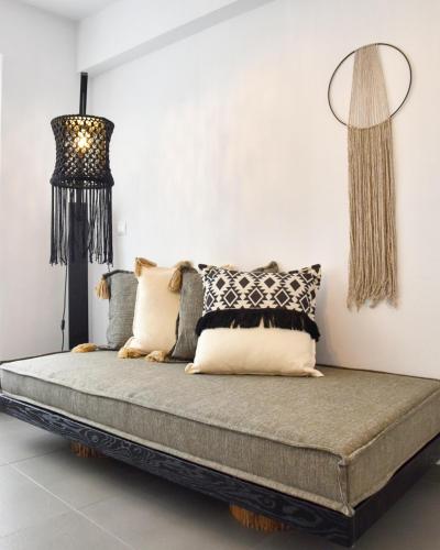 a bed with pillows on it in a room at Angelos Design Suites in Patitiri