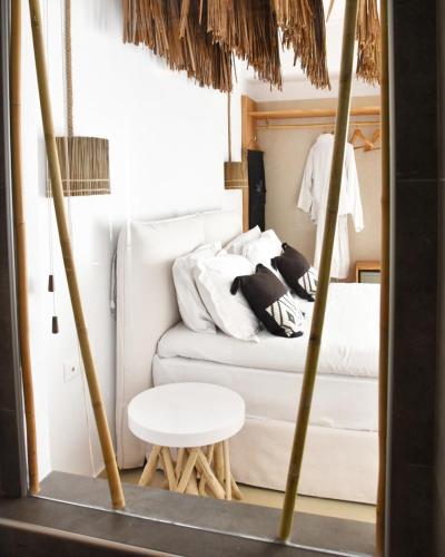 a room with a white couch and a table at Angelos Design Suites in Patitiri