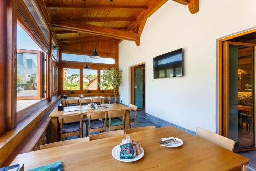 a dining room with wooden tables and chairs at Restaurace a penzion Pod Lipami Metylovice in Metylovice