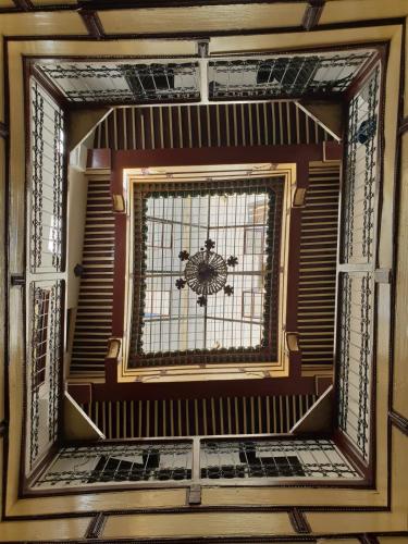 a glass window in a room with a ceiling at Moroccan Dream Hostel in Fès