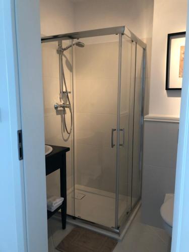 a shower with a glass door in a bathroom at La Masuria in Ruciane-Nida