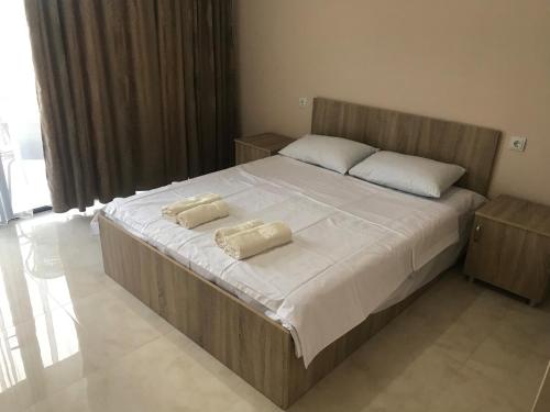 a bedroom with a large bed with two pillows on it at ALEX'S HOUSE in K'obulet'i