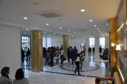 a group of people walking in a building at Hotel Uzbekistan in Urganch