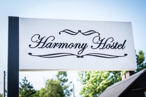 a sign for a hamney hotel on a building at Harmony Hostel in Zator