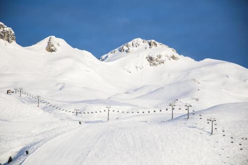a snow covered mountain with a ski lift at Burgi's - Adults only in Lech am Arlberg