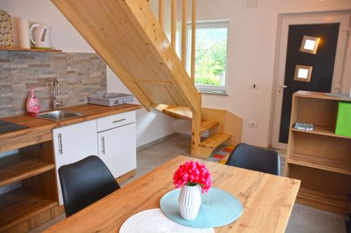 a kitchen and dining room with a table and chairs at HišaŠmihelka in Kobarid