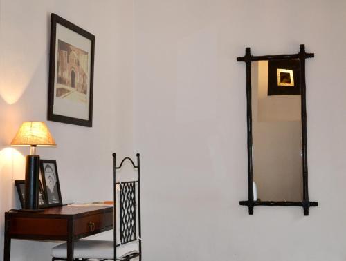 a living room with a mirror and a table at Riad Kasbah & Spa in Marrakesh