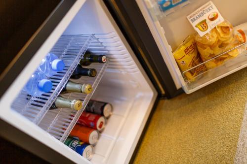a refrigerator filled with bottles of wine and food at Restaurace a penzion Pod Lipami Metylovice in Metylovice