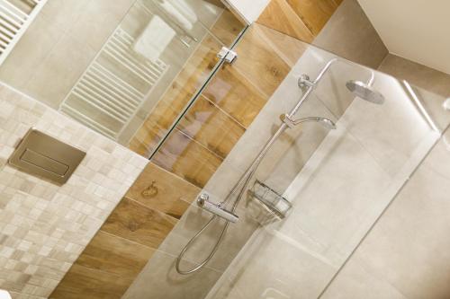 a bathroom with a shower with a glass door at Restaurace a penzion Pod Lipami Metylovice in Metylovice