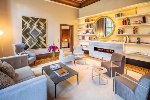 a living room filled with furniture and a fireplace at Fraser Suites Hamburg in Hamburg