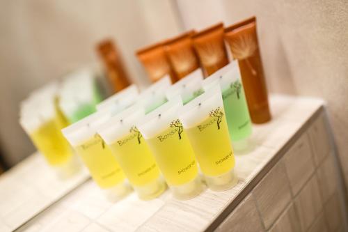 a row of cups sitting on a counter in a bathroom at Restaurace a penzion Pod Lipami Metylovice in Metylovice