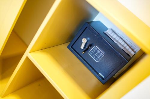 a black box on a yellow shelf with a screwdriver at Restaurace a penzion Pod Lipami Metylovice in Metylovice