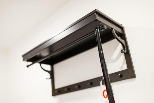 a black flush mount light hanging on a wall at Restaurace a penzion Pod Lipami Metylovice in Metylovice
