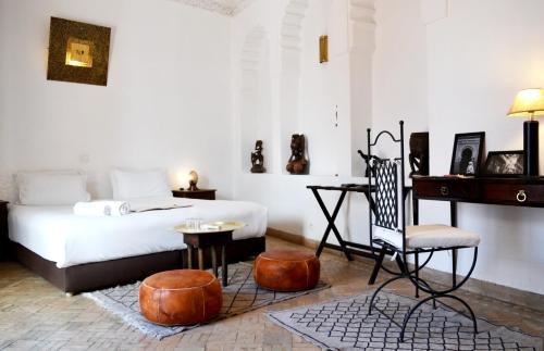 a bedroom with a bed and a desk and a chair at Riad Kasbah & Spa in Marrakesh