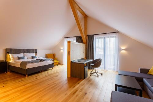 a bedroom with a bed and a desk in a room at Restaurace a penzion Pod Lipami Metylovice in Metylovice