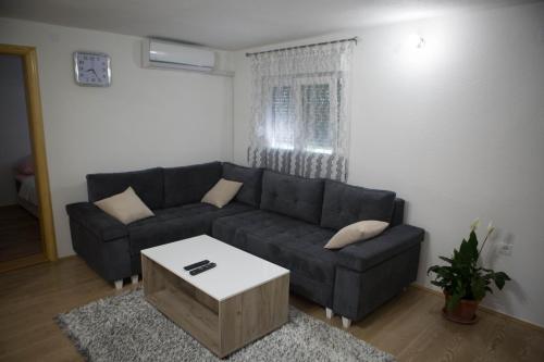 a living room with a couch and a coffee table at Apartman Miloš in Trebinje