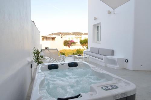 a bath tub in the middle of a living room at Ostria Hotel  in Adamas