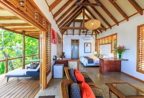 a living room with a couch and a bed at Savasi Island Resort in Savusavu