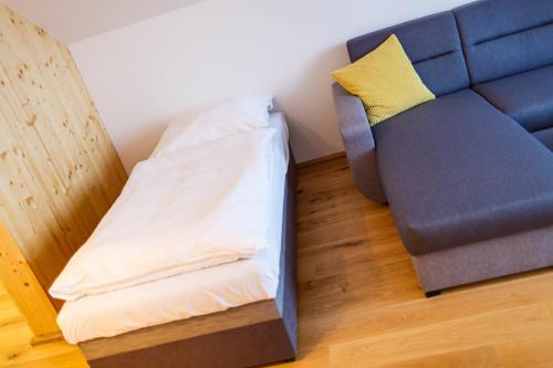 a couch and a chair in a room at Restaurace a penzion Pod Lipami Metylovice in Metylovice