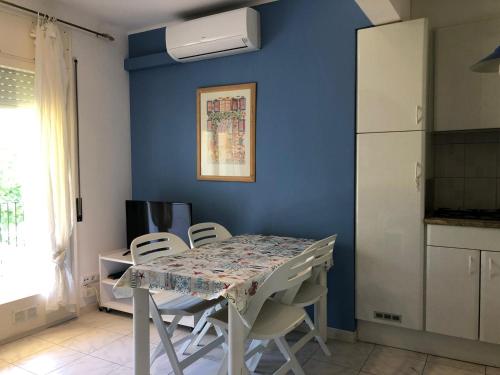 エンプリアブラバにあるXaloc Empuriabravaの青い壁のキッチン(テーブル、椅子付)