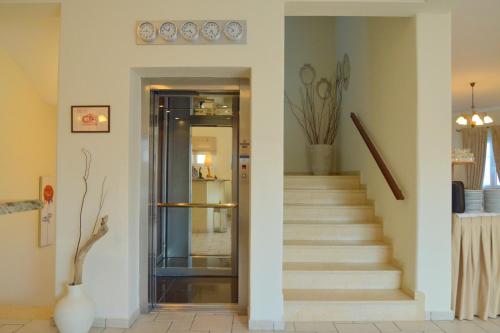 a hallway with a staircase with a glass door at Ostria Hotel  in Adamas