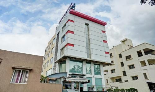 a tall white building with red trim at Treebo Trend Bhagyashree Executive Hadapsar in Pune