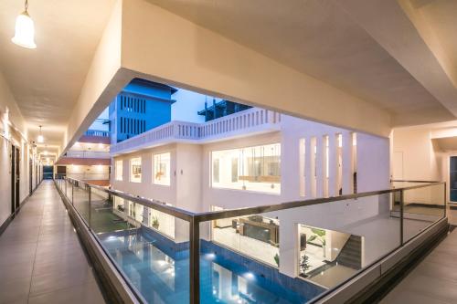 an indoor pool in the middle of a building at Regenta Central North Goa, Arpora in Arpora