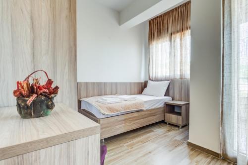 a small room with a bed and a window at Adriatik Lux Apartments in Budva
