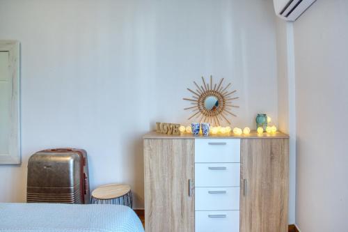 a bedroom with a dresser and a mirror on the wall at Plaza Filellinon in Nafplio