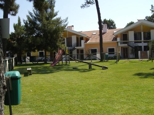 a yard with a playground with a slide at Aldeamento Turistico Casas da Comporta in Comporta