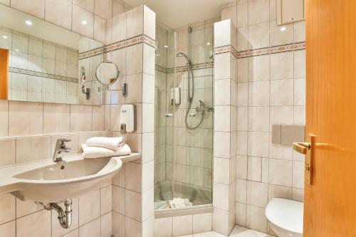 a bathroom with a sink and a shower at Hotel-Restaurant zum Ochsen in Schallstadt