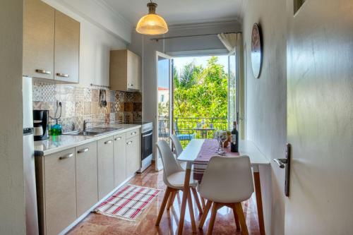 a kitchen with a table and chairs and a window at Plaza Filellinon in Nafplio