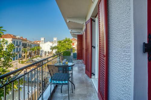 a balcony with a table and chairs on a building at Plaza Filellinon in Nafplio