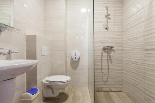 a bathroom with a shower and a toilet and a sink at Adriatik Lux Apartments in Budva